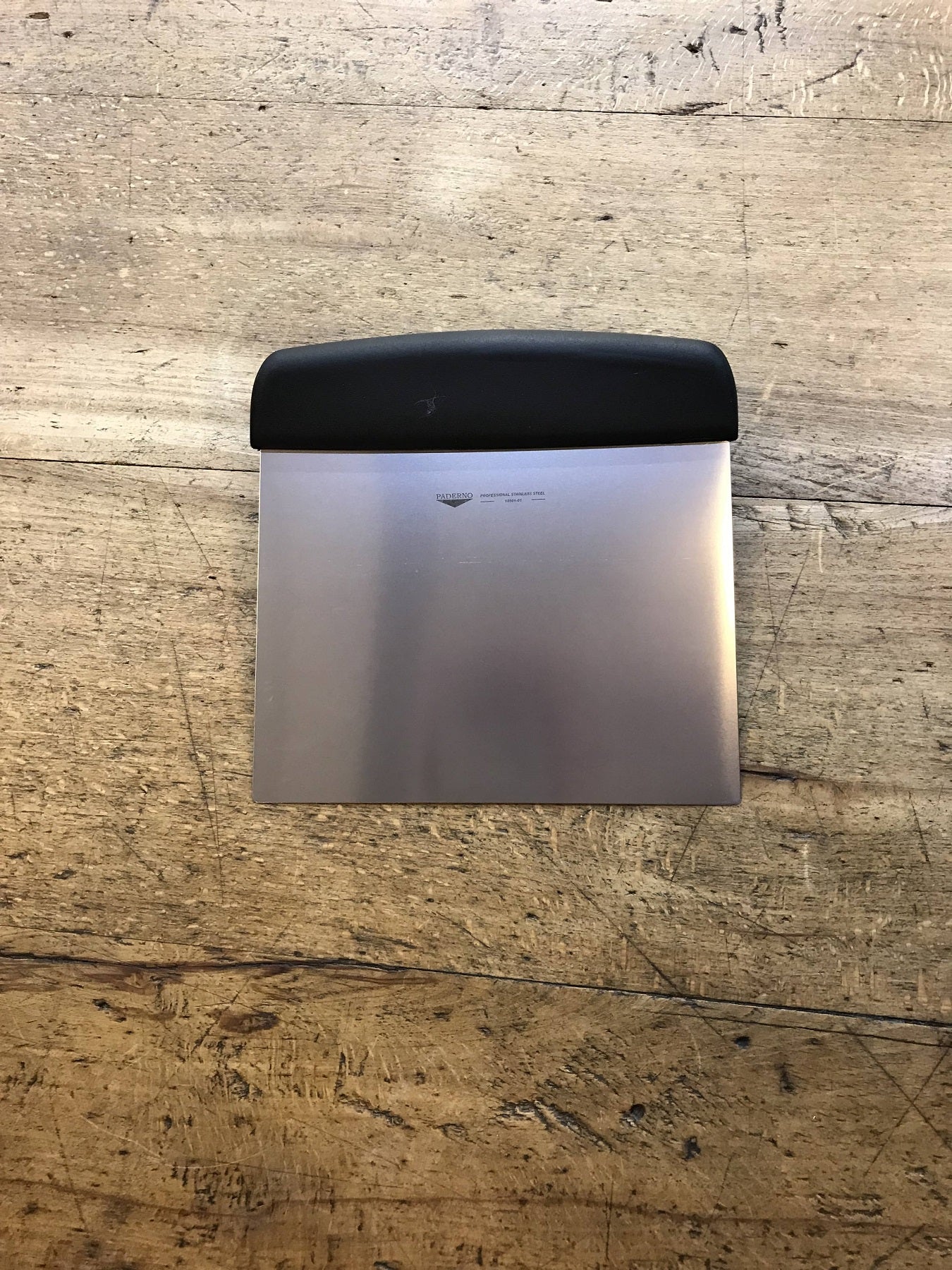 Small rigid cutting board scraper