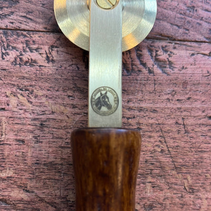 Brass spur with smooth wooden handle
